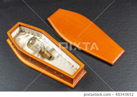 Burned Out Light Bulb popped and smoked in coffin.Concept 48343652