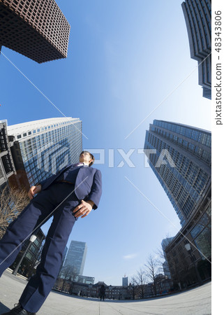 Businessman stands super wide-angle fisheye shooting 48343806