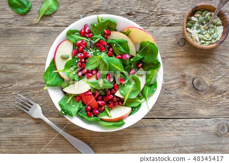 Spinach, apple salad with pomegranate seeds 48345417