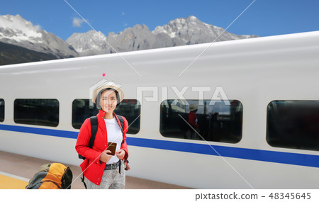 solo travelling middle aged tourist with train 48345645