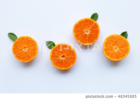 Orange fruits and green leaves on a white Orange fruits and green leaves on a white 48345885