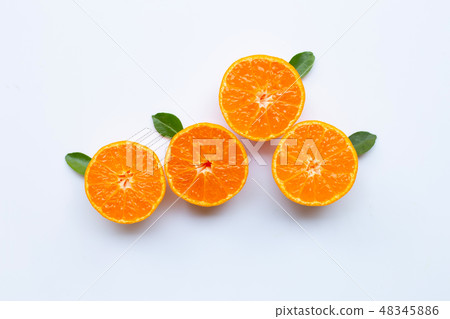 Orange fruits and green leaves on a white Orange fruits and green leaves on a white 48345886