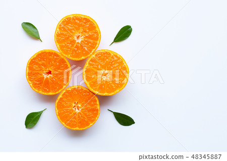 Orange fruits and green leaves on a white  48345887
