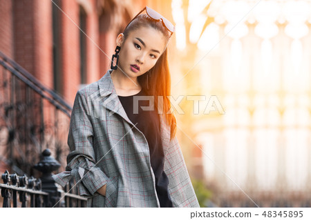 Beautiful young Asian fashion model woman walking Beautiful young Asian fashion model woman walking 48345895