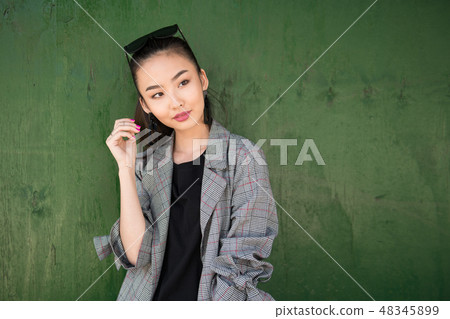 Beautiful asian woman having fun and hold her hair Beautiful asian woman having fun and hold her hair 48345899
