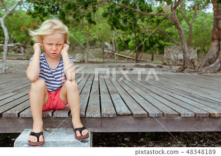 Face portrait of annoyed, unhappy kid  48348189