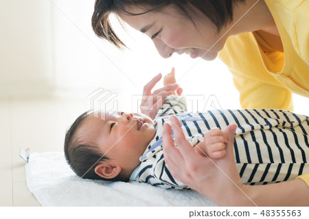 A young mother who babies a baby Japanese woman A young mother who babies a baby Japanese woman 48355563