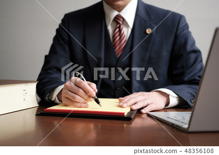 Male attorney notes on legal pad Male attorney notes on legal pad 48356108