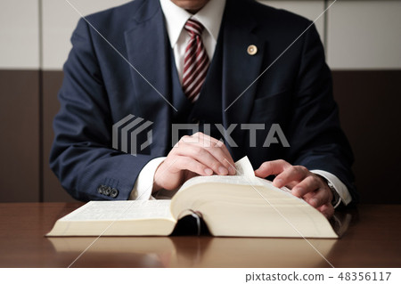 Handy of a lawyer studying the law 48356117