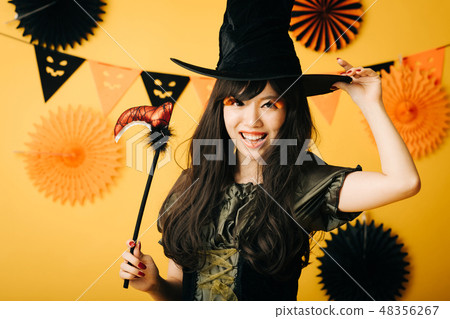 A young girl who makes a witch's cosplay in Halloween Japanese women A young girl who makes a witch's cosplay in Halloween Japanese women 48356267