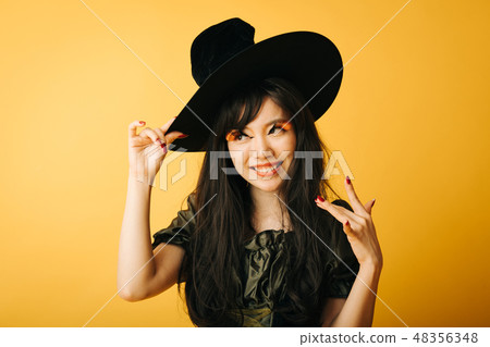 A young girl who makes a witch's cosplay in Halloween Japanese women A young girl who makes a witch's cosplay in Halloween Japanese women 48356348
