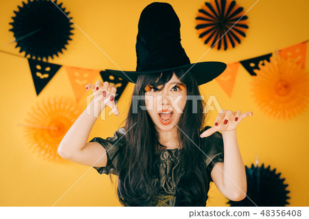 A young girl who makes a witch's cosplay in Halloween Japanese women A young girl who makes a witch's cosplay in Halloween Japanese women 48356408