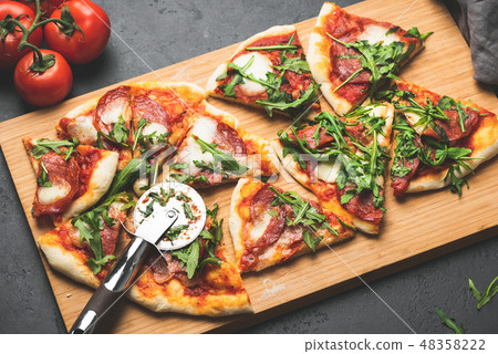 Pizza or flatbread with arugula, salami, cheese Pizza or flatbread with arugula, salami, cheese 48358222