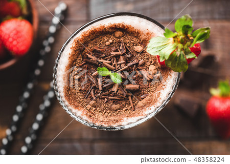 Chocolate milkshake in glass closeup view Chocolate milkshake in glass closeup view 48358224