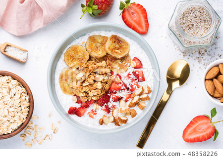 Superfood smoothie bowl with banana and granola Superfood smoothie bowl with banana and granola 48358226