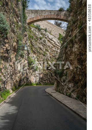 Arched bridge over the narrow road Arched bridge over the narrow road 48358638