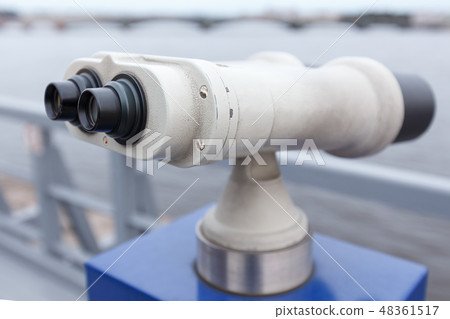 Coin operated binocular on the bank of river 48361517