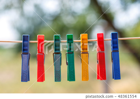 Colored clothespins on a rope Colored clothespins on a rope 48361554
