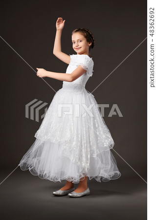 little girl is in white ball gown, dark background little girl is in white ball gown, dark background 48362692