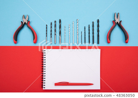set of metalwork tools with notebook and pen on colorful background 48363050