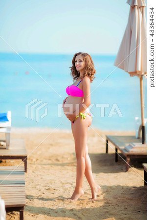 woman in bikini on lounge chair 48364434