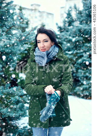 beautiful woman in winter forest, green fir trees beautiful woman in winter forest, green fir trees 48365106