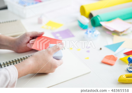 Woman's hand cut paper Making a scrap booking or other festive d Woman's hand cut paper Making a scrap booking or other festive d 48365558