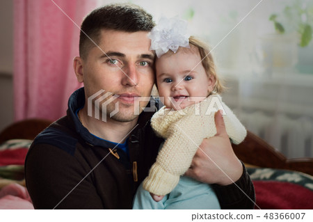 Father with a little daughter sitting in a cozy  48366007
