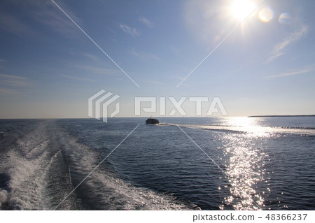 The wake of a high-speed boat in the morning glow of Okinawa Okinawa Tourism 48366237