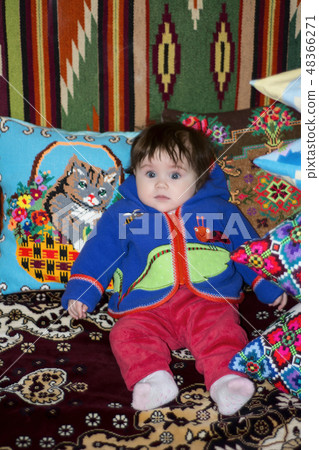 Amazing little girl sitting in bed on a bed Amazing little girl sitting in bed on a bed 48366271