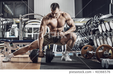 guy bodybuilder with dumbbell 48366576