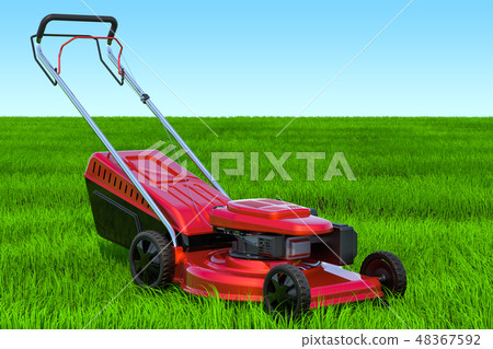 Lawn mower in the green grass against blue sky 48367592