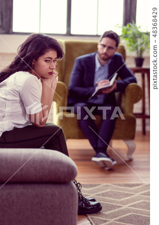 Depressed nice woman sitting in the armchair 48368429