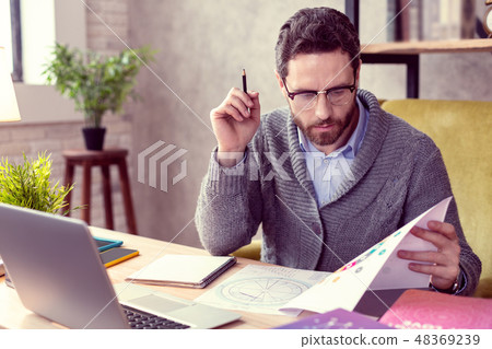 Nice intelligent man focusing on his work 48369239