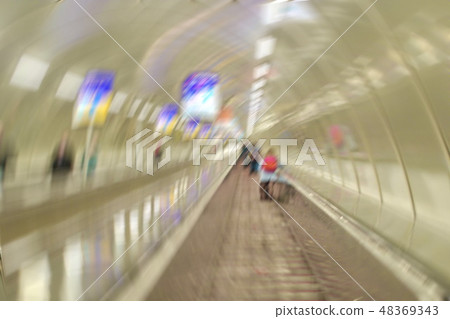 Circular blurred image of people moving on the escalator in the Circular blurred image of people moving on the escalator in the 48369343