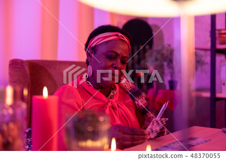 African american plump fortune-teller with huge earrings making a prediction African american plump fortune-teller with huge earrings making a prediction 48370055
