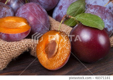 plum on the wooden background with sackcloth 48371181
