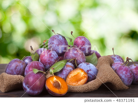 plum on the sackcloth with blurred background 48371191