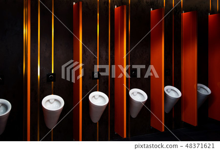 Modern toilet with urinals and orange walls Modern toilet with urinals and orange walls 48371621