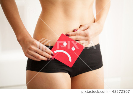Vaginal or urinary infection and problems concept. Young woman holds paper with SOS above crotch 48372507