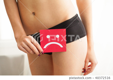 Vaginal or urinary infection and problems concept. Young woman holds paper with SOS above crotch 48372516