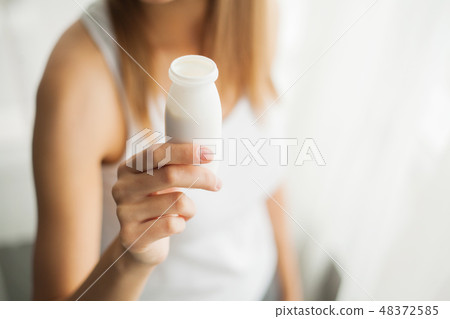 Healthy Breakfast. Young woman at home eating yogurt Healthy Breakfast. Young woman at home eating yogurt 48372585