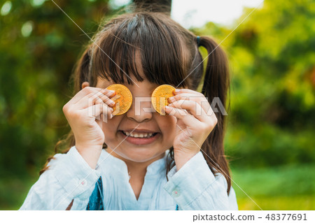 Little girl kid holding bitcoin digital money. 48377691