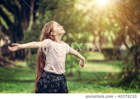 Happy cute little girl playing in the park. Happy cute little girl playing in the park. 48378230