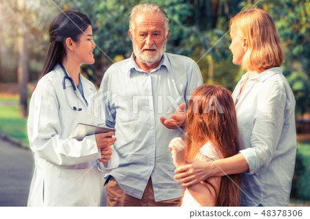 Happy healthy family and doctor talking in park. 48378306
