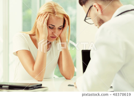 Male Doctor and Female Patient in Hospital Office 48378619