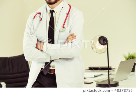 Male doctor crossed arms standing in the hospital. 48378755