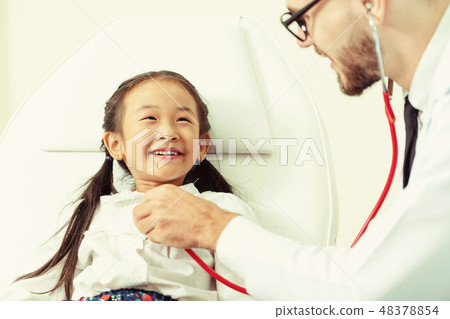 Doctor examining little happy kid in hospital. Doctor examining little happy kid in hospital. 48378854