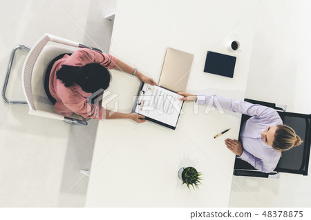 Two young business women meeting for interview. 48378875