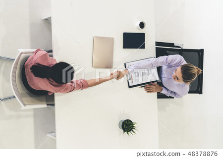 Two young business women meeting for interview. Two young business women meeting for interview. 48378876